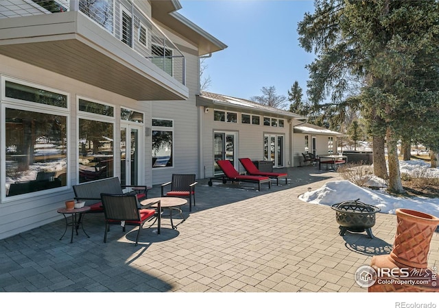 view of patio / terrace with a fire pit and french doors