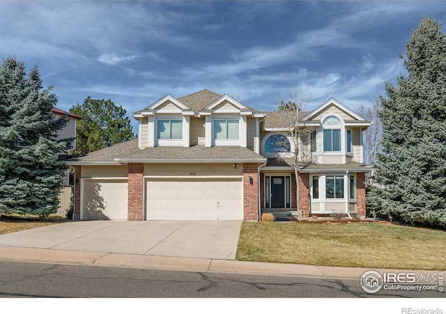 view of front of home featuring brick siding, concrete driveway, and a front lawn