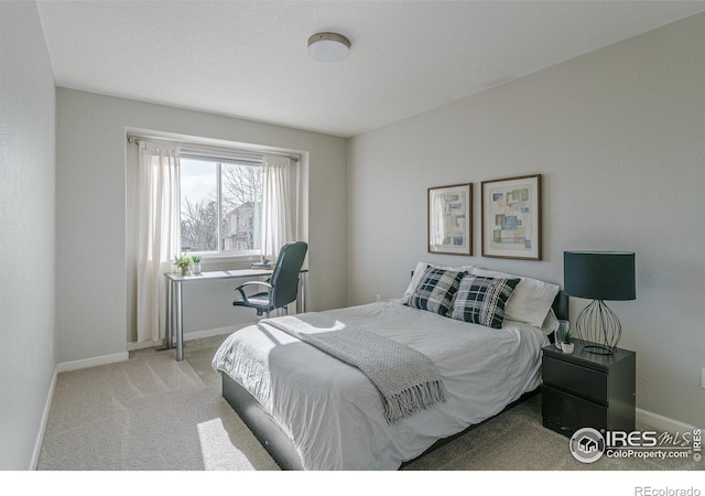 carpeted bedroom featuring baseboards