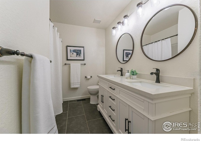 bathroom with tile patterned flooring, visible vents, toilet, double vanity, and a sink