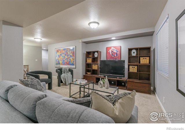 carpeted living room with baseboards