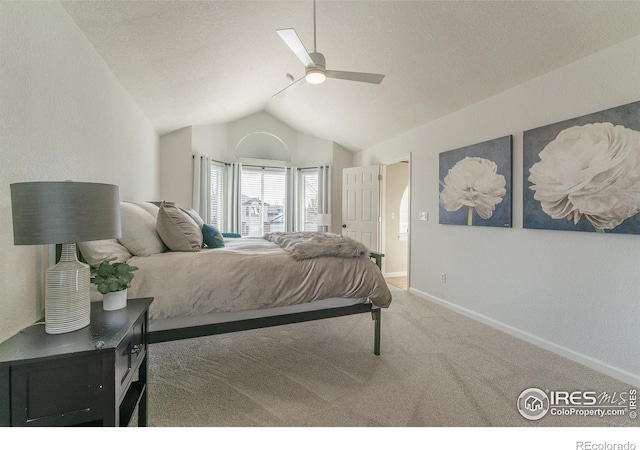 carpeted bedroom with ceiling fan, a textured ceiling, baseboards, and vaulted ceiling