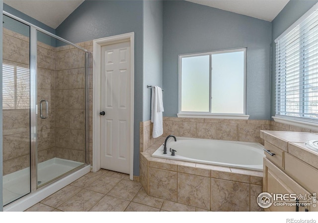 bathroom with a shower stall, tile patterned flooring, lofted ceiling, a bath, and vanity