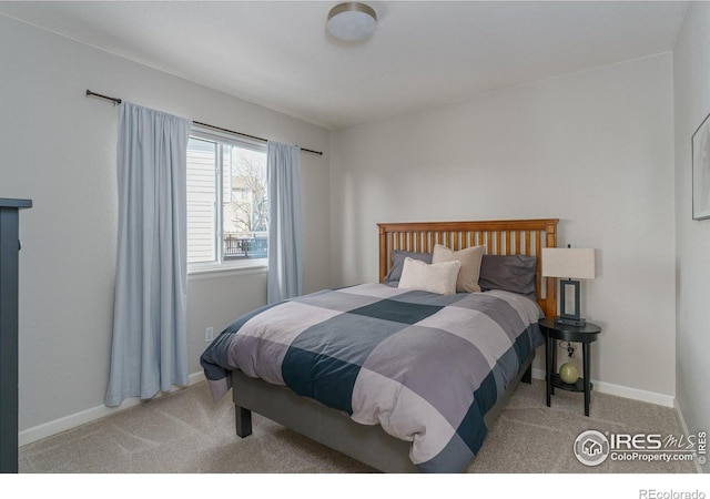 carpeted bedroom featuring baseboards