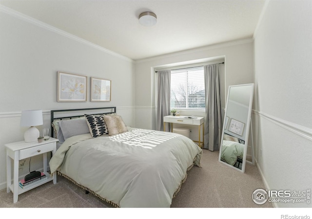 bedroom with ornamental molding, baseboards, and light carpet