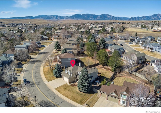 birds eye view of property featuring a mountain view and a residential view