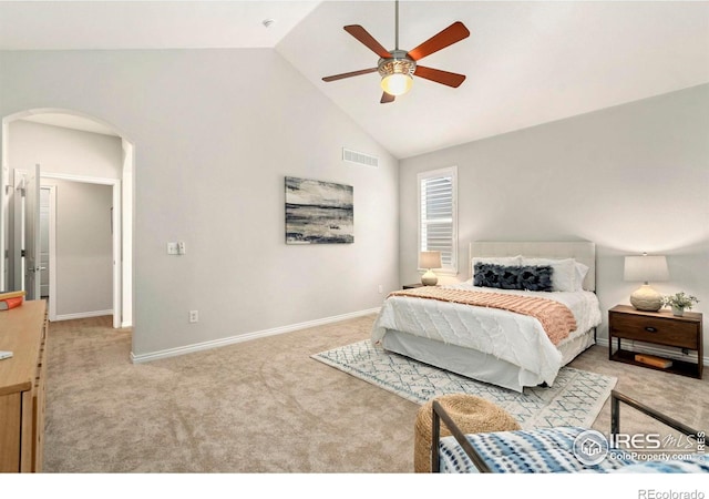 bedroom featuring visible vents, light carpet, high vaulted ceiling, arched walkways, and baseboards