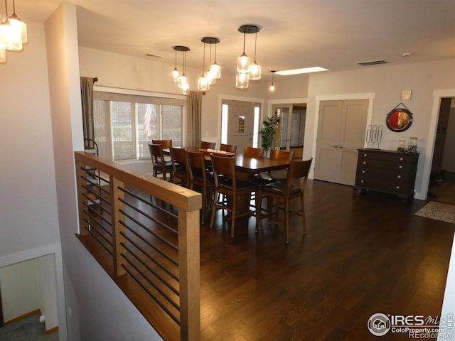 dining room with visible vents, wood finished floors, and a chandelier