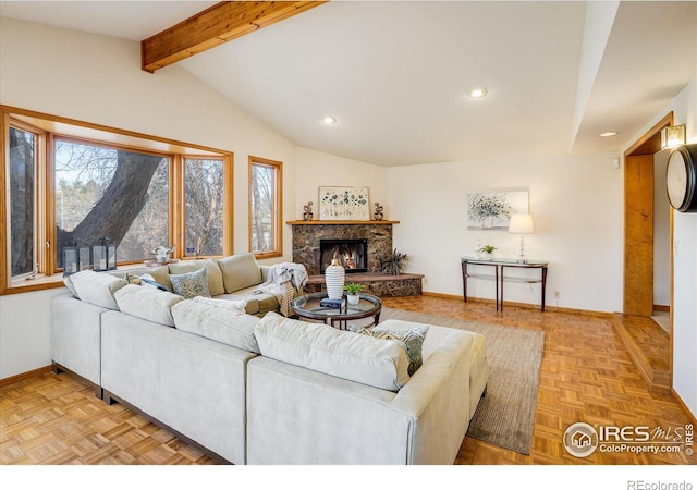 living area featuring a stone fireplace, lofted ceiling with beams, recessed lighting, and baseboards