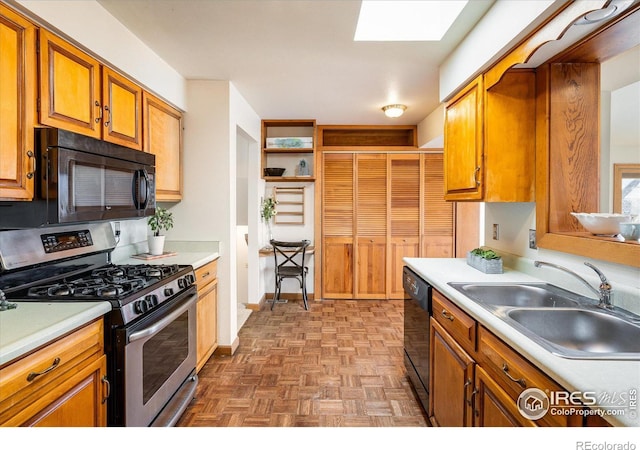 kitchen with black microwave, gas range, light countertops, dishwashing machine, and a sink