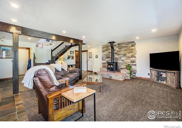 living room with stairway, recessed lighting, and a wood stove