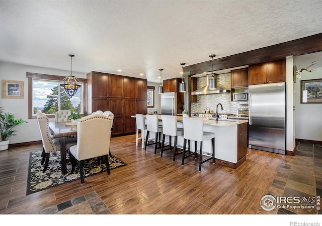 dining room with a chandelier, a textured ceiling, dark wood-type flooring, and baseboards