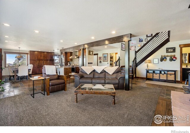 living area featuring stairway, recessed lighting, and baseboards