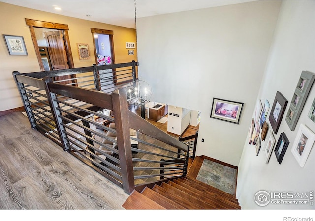 stairway featuring baseboards and wood finished floors