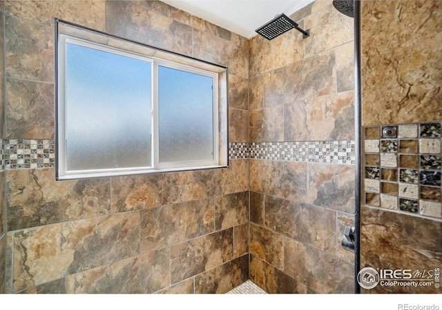 interior details featuring a tile shower