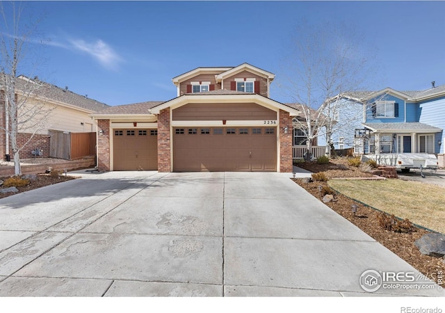 view of front of house featuring brick siding, an attached garage, and driveway