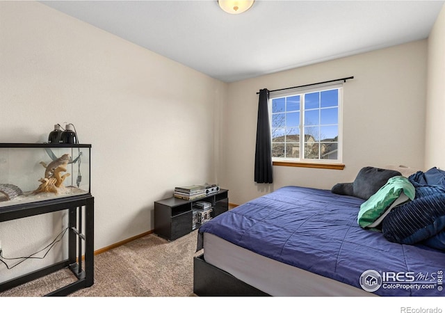 carpeted bedroom with baseboards