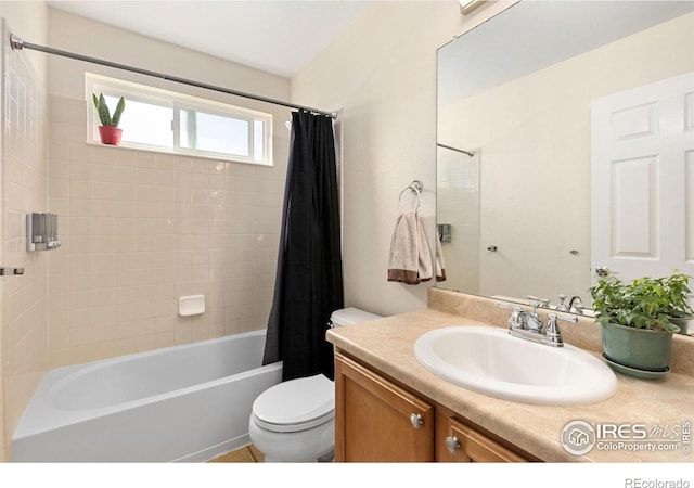 full bath with vanity, toilet, and shower / tub combo with curtain