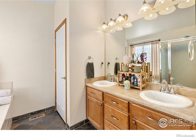 bathroom with a sink, visible vents, a stall shower, and double vanity