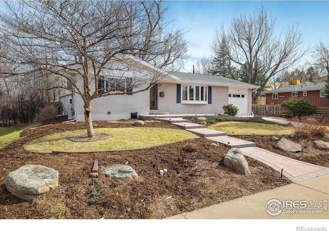 ranch-style house featuring a front yard, an attached garage, fence, and brick siding