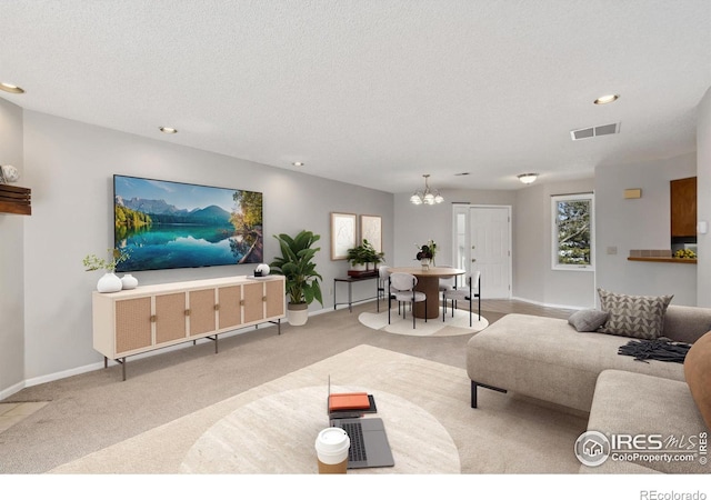 living room featuring visible vents, recessed lighting, a textured ceiling, and baseboards