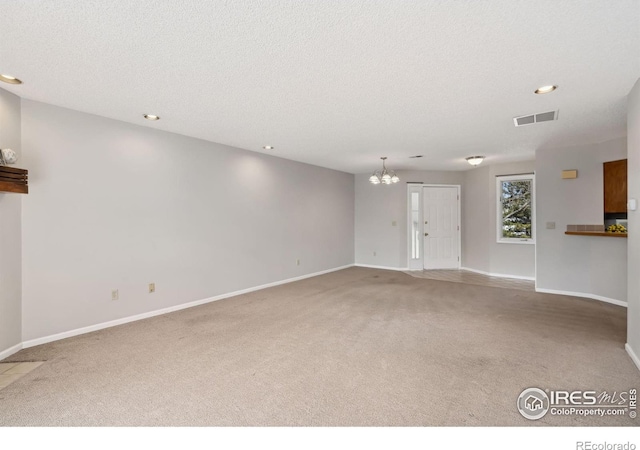 unfurnished living room featuring carpet flooring, baseboards, and visible vents