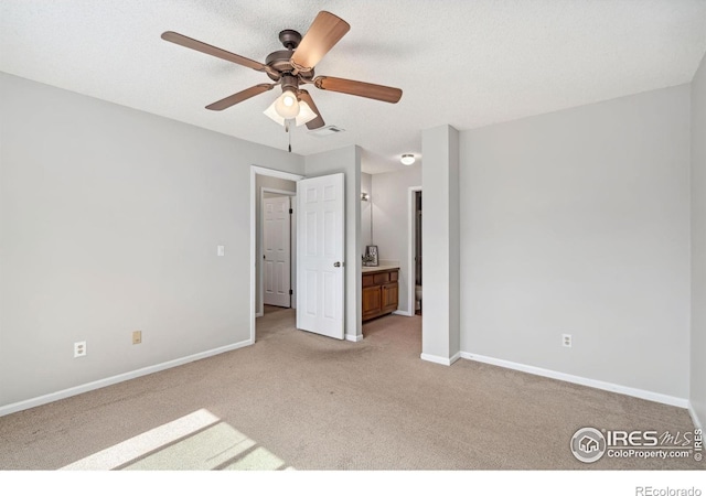 unfurnished bedroom featuring baseboards, light carpet, visible vents, and ensuite bath