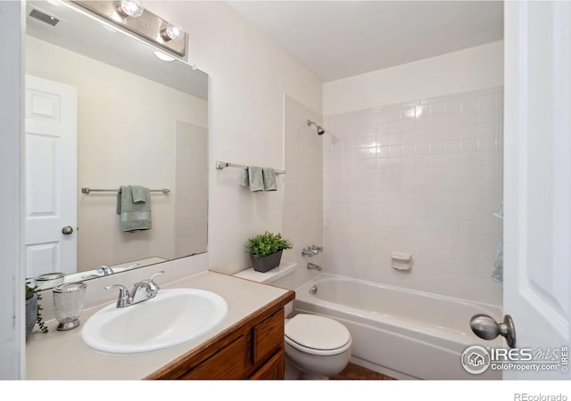 full bath featuring visible vents, toilet, bathtub / shower combination, and vanity