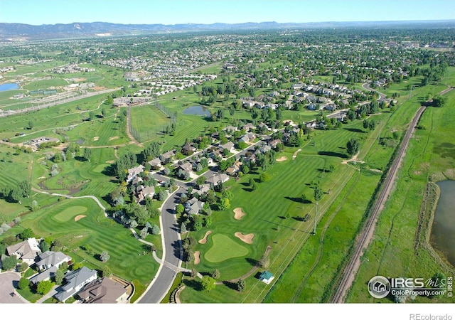 drone / aerial view featuring a residential view, a water view, and view of golf course