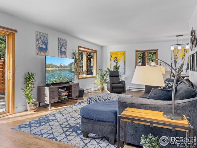 living room featuring a baseboard heating unit, wood finished floors, and baseboard heating