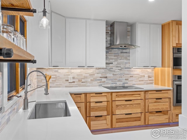 kitchen with oven, wall chimney range hood, black electric cooktop, and a sink