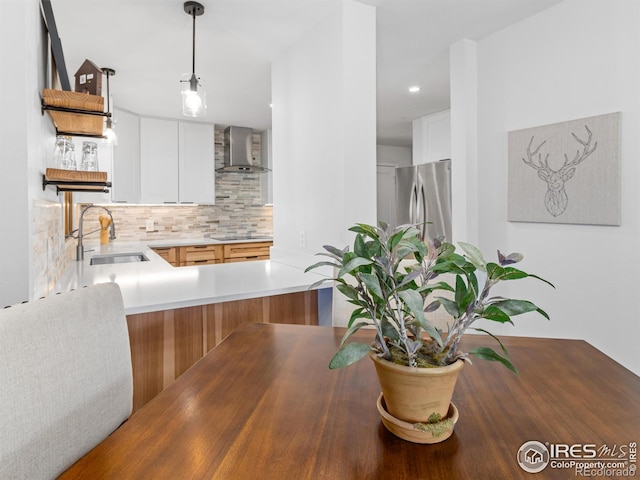 kitchen with open shelves, a sink, black electric stovetop, wall chimney exhaust hood, and tasteful backsplash