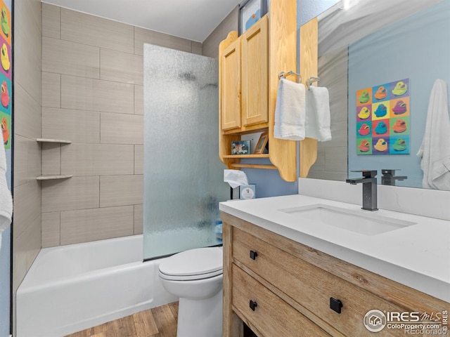 full bath featuring toilet, vanity, bathtub / shower combination, and wood finished floors