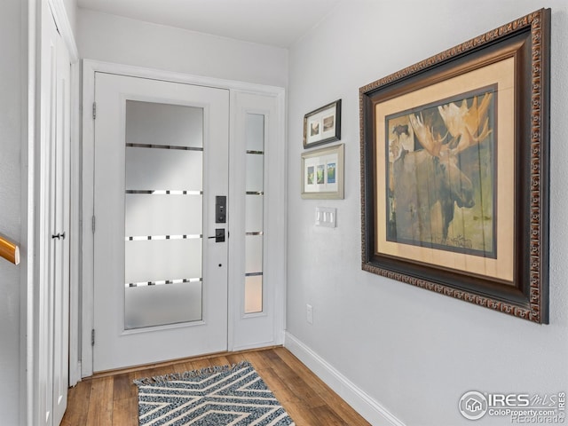 entryway featuring baseboards and wood finished floors