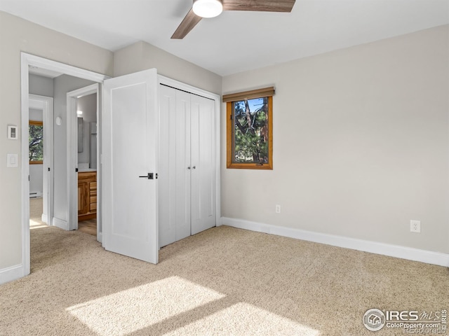 unfurnished bedroom featuring a closet, a ceiling fan, baseboards, and carpet floors