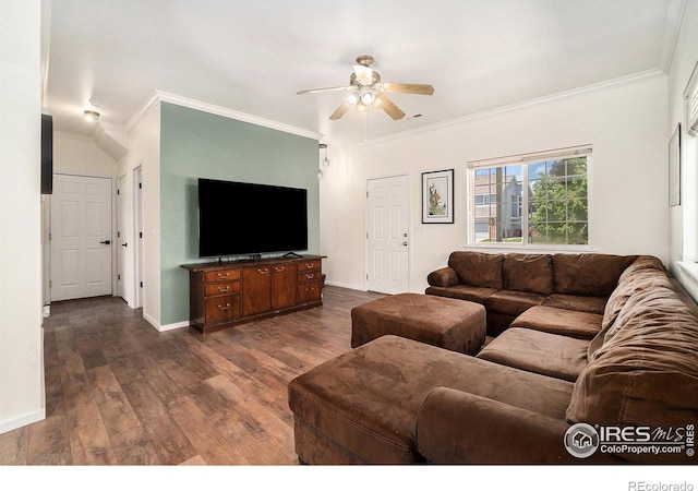 living room with dark wood-type flooring, a ceiling fan, baseboards, and ornamental molding