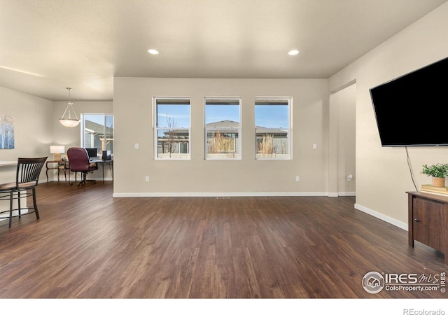 3948 Hackberry St, Wellington, CO 80549 - living area featuring dark wood finished floors, recessed lighting, and baseboards