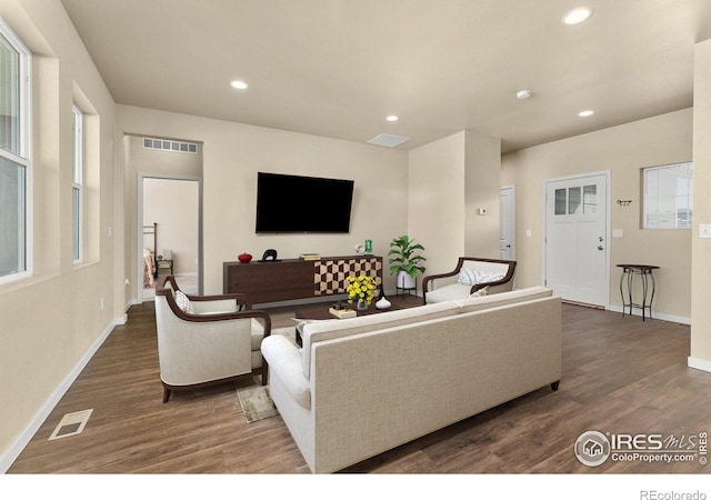 3948 Hackberry St, Wellington, CO 80549 - living room with wood finished floors, recessed lighting, visible vents, and baseboards