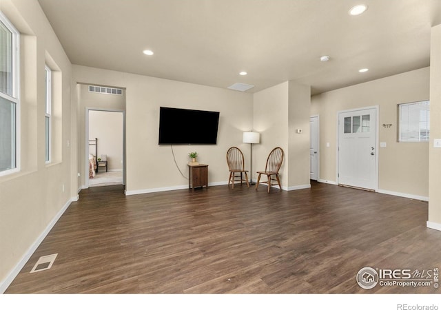 3948 Hackberry St, Wellington, CO 80549 - living room with dark wood-type flooring, recessed lighting, visible vents, and baseboards