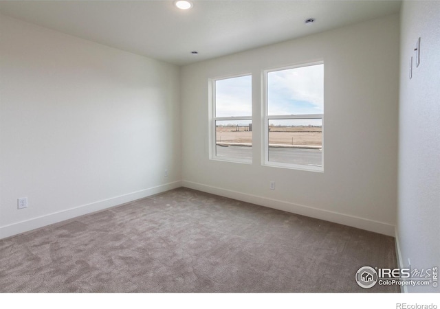 empty room with recessed lighting, baseboards, and carpet