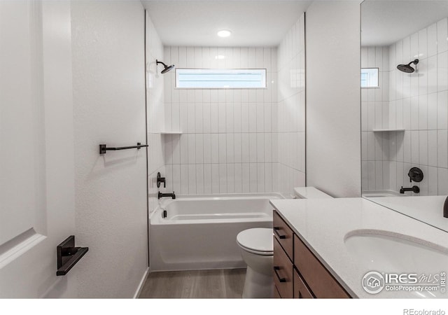 bathroom featuring shower / bath combination, toilet, wood finished floors, and vanity