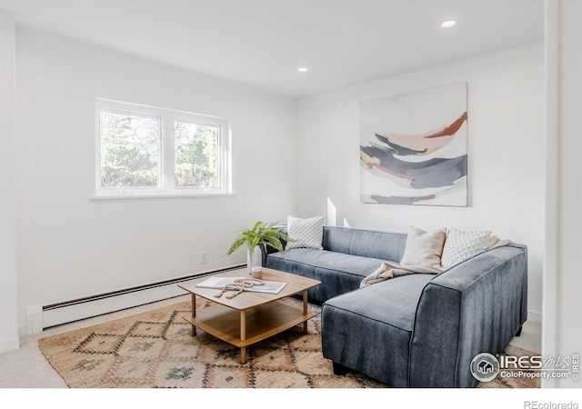 living area with a baseboard heating unit, recessed lighting, and carpet