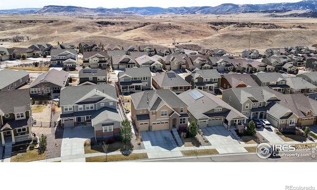 birds eye view of property with a mountain view and a residential view