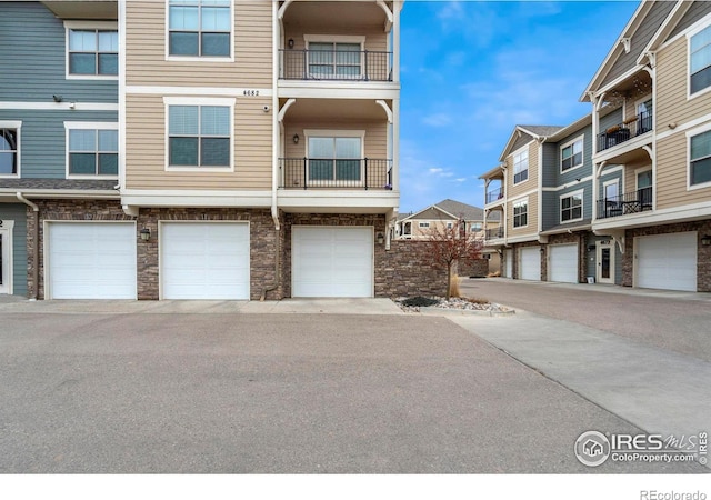 exterior space with stone siding and an attached garage