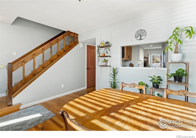 bedroom featuring baseboards and wood finished floors