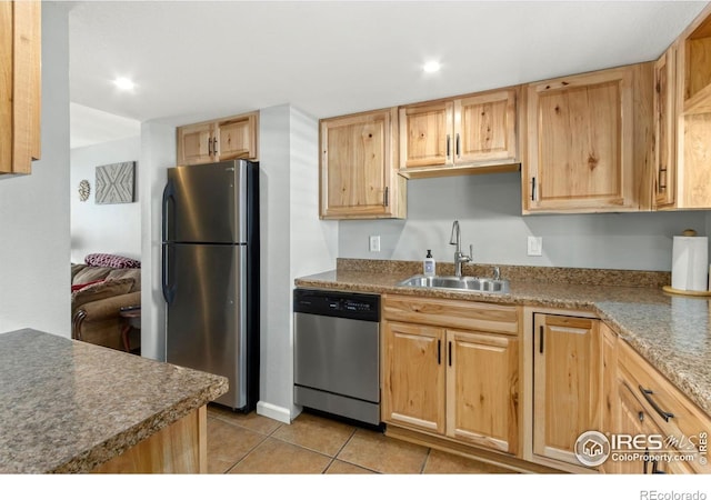 kitchen with light brown cabinets, light tile patterned flooring, recessed lighting, a sink, and stainless steel appliances