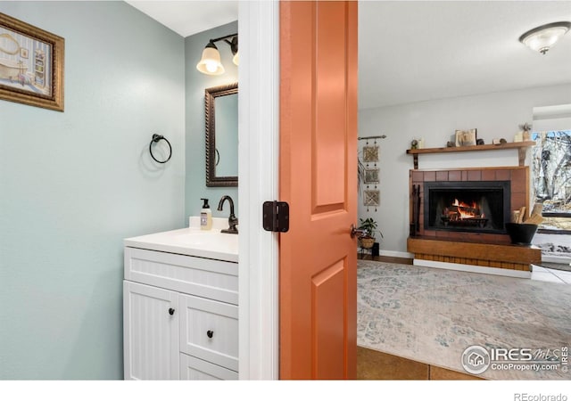 bathroom with a fireplace and vanity