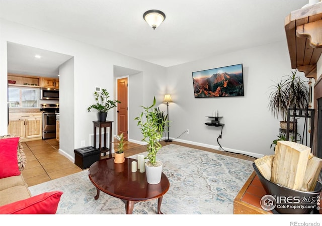 living room with baseboards and light tile patterned flooring