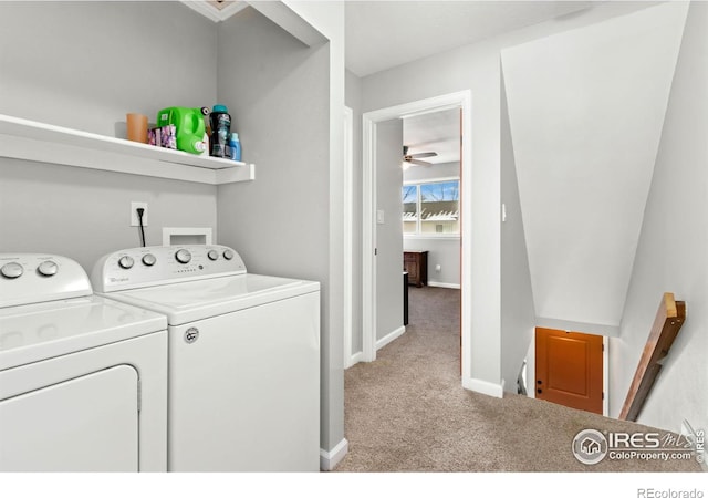 laundry room with washer and dryer, laundry area, light colored carpet, and baseboards