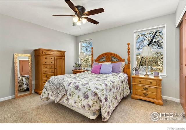 bedroom with baseboards, light colored carpet, and a ceiling fan